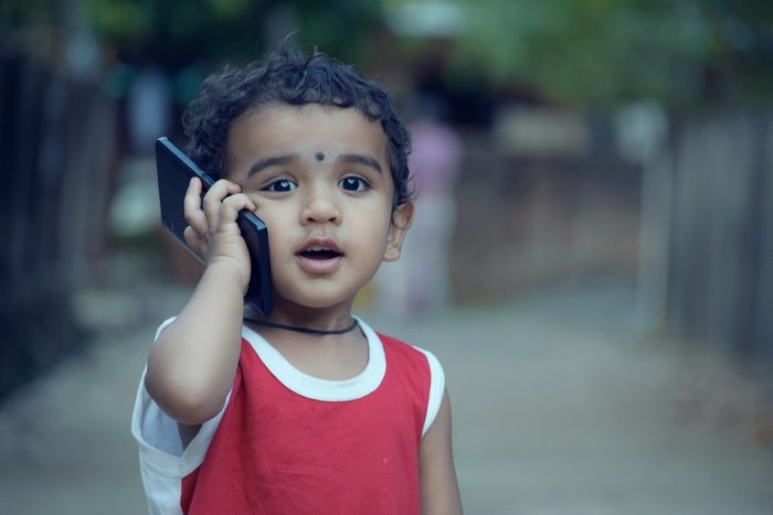 A child with a toy phone - You might wonder why a child would want a mobile phone, and you’re more apt to get a gaming mobile for them.