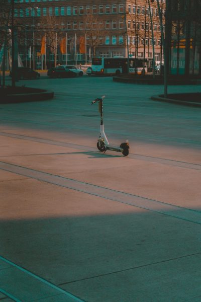 White scooter left in the middle of the road.