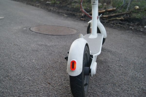 A white moped with black wheels