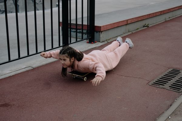 A preschooler skateboarding.