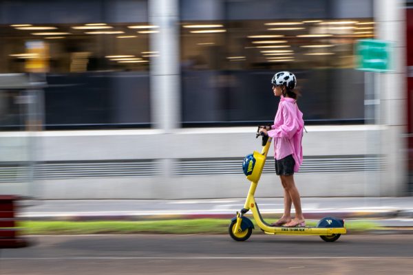 A girl is having a fun ride while wearing a helmet.