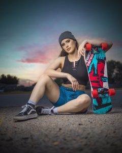 Skateboarding gear on a budget - a woman holding her board