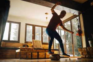 A man is using a balance board.