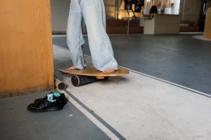 A half human body practicing for his or her skills in using a balance board. 