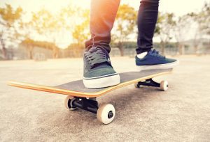 A skater riding on a skateboard with his black skateboard shoes ready for skateboarding session. - DIY